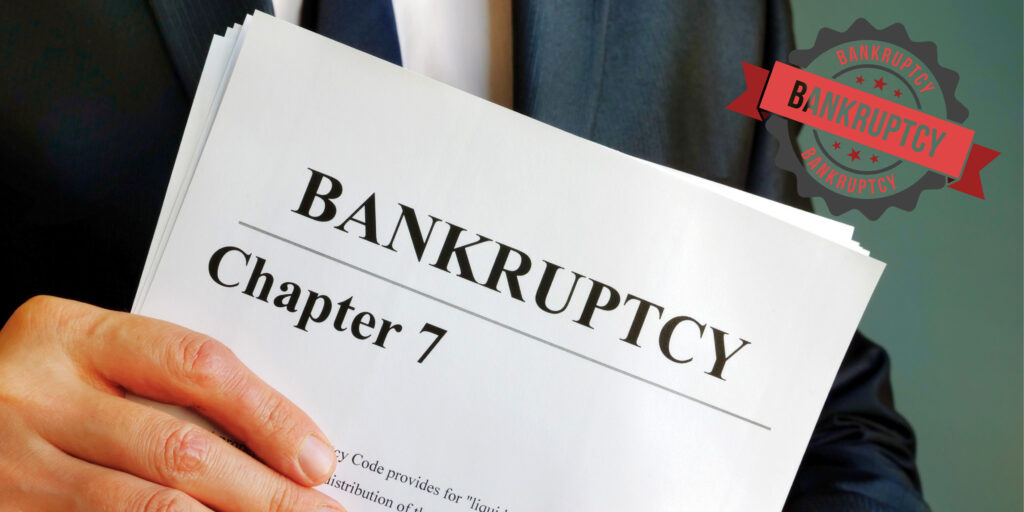 Client and bankruptcy attorney shaking hands in a Coral Springs office after receiving a Chapter 7 debt discharge from the U.S. Bankruptcy Court.